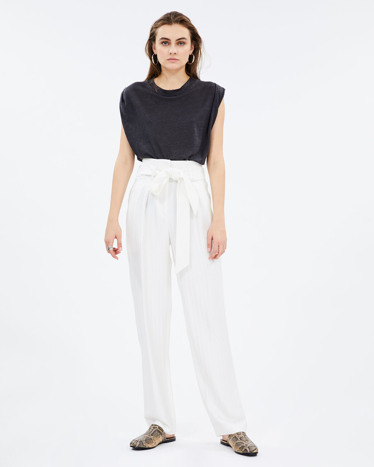Photo of IRO Paris Cinca Pants Ecru - These Geometrically Shaped Pants Are Distinguished By Their Waist Belt. Their Plus? Their Fluidity Which Will Bring A Casual Touch To Your Outfits In Summer. Wear Them With A Black Top And A Pair Of Sandals For A Fresh And Sunny Silhouette. Trousers